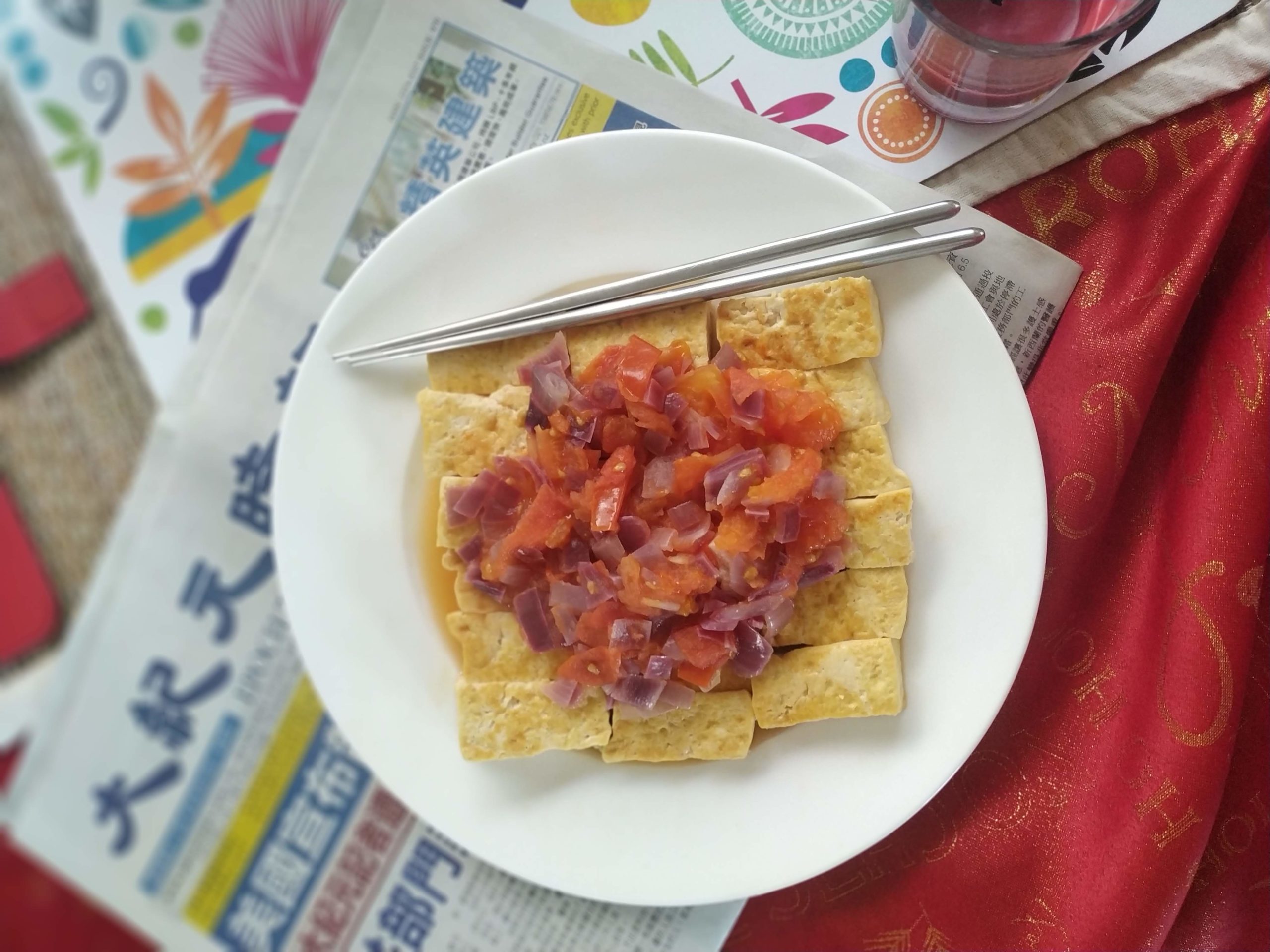 vegan chinese "egg" and tomato on a white plate