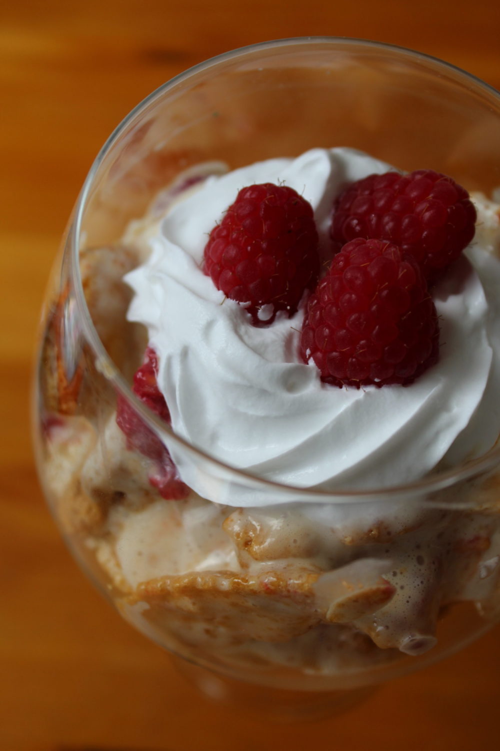 vegan dessert with honeycomb and raspberries in a glass
