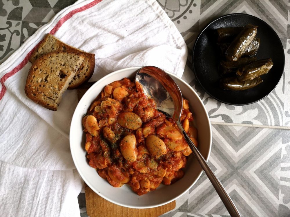 gigantes beans in a bowl with bread and a spoon