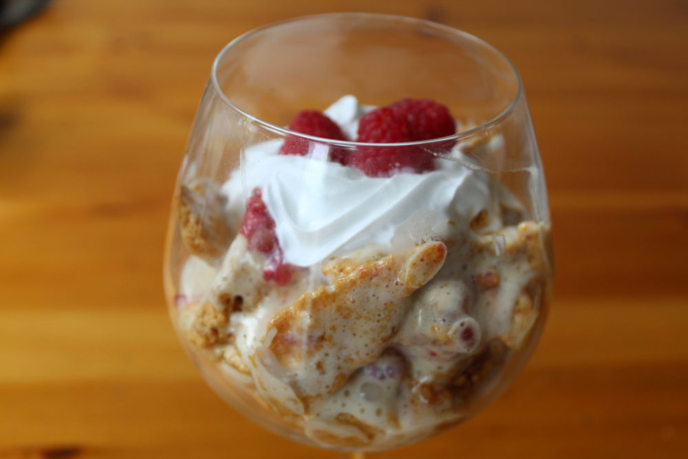 vegan dessert with honeycomb and raspberries in a glass