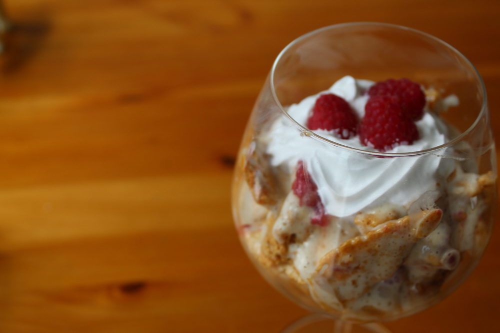 vegan dessert with honeycomb and raspberries in a glass