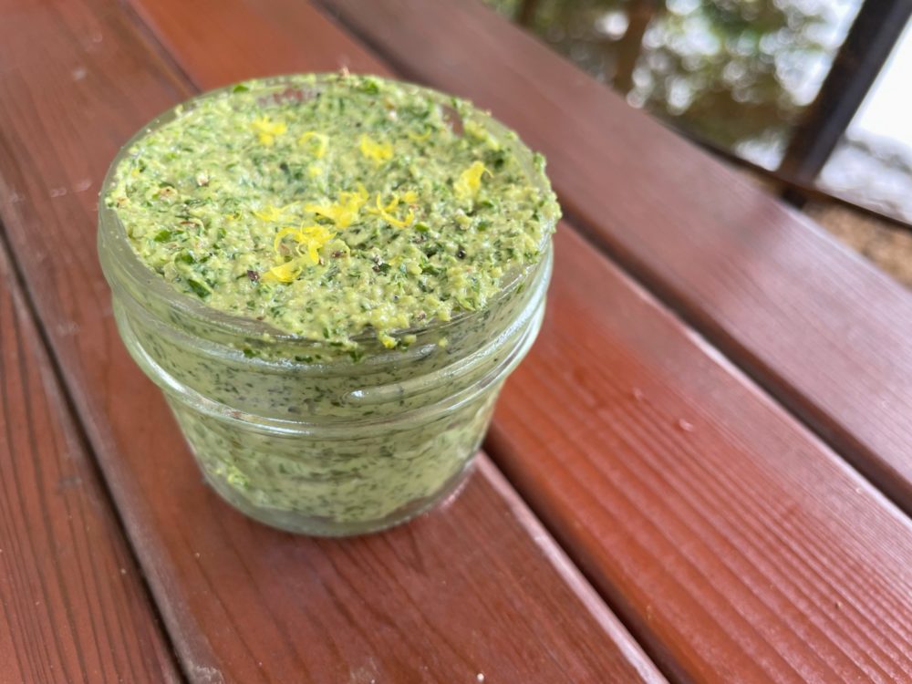 jar of kale lemon pesto on a red table