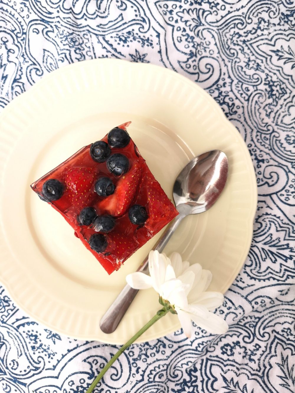 summer fruit cake bars on a white plate with a spoon