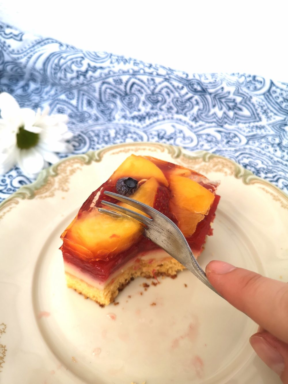 summer fruit cake bars on a white plate with a fork