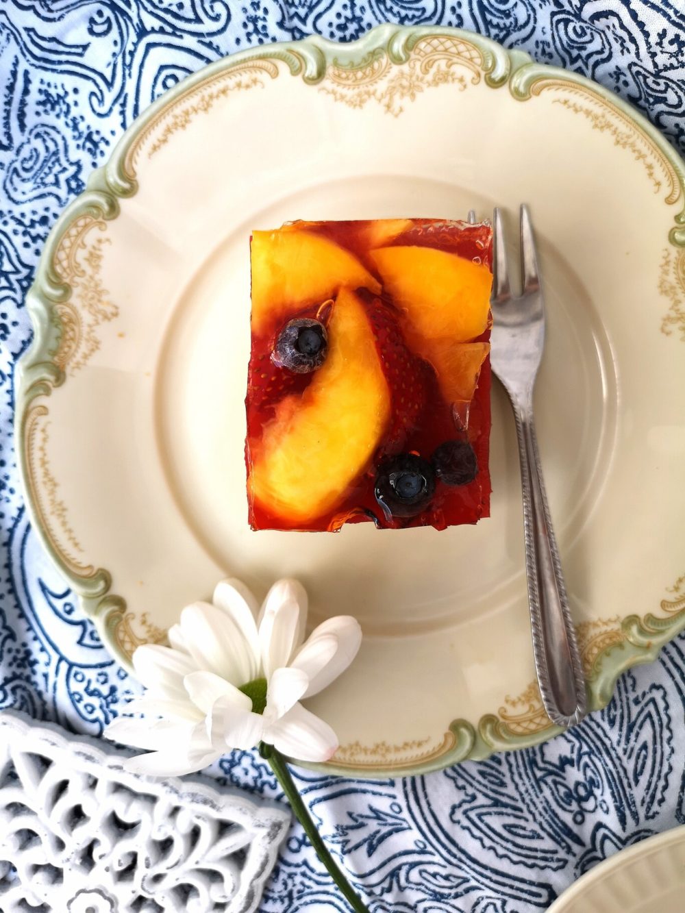 summer fruit cake bars on a white plate with a fork