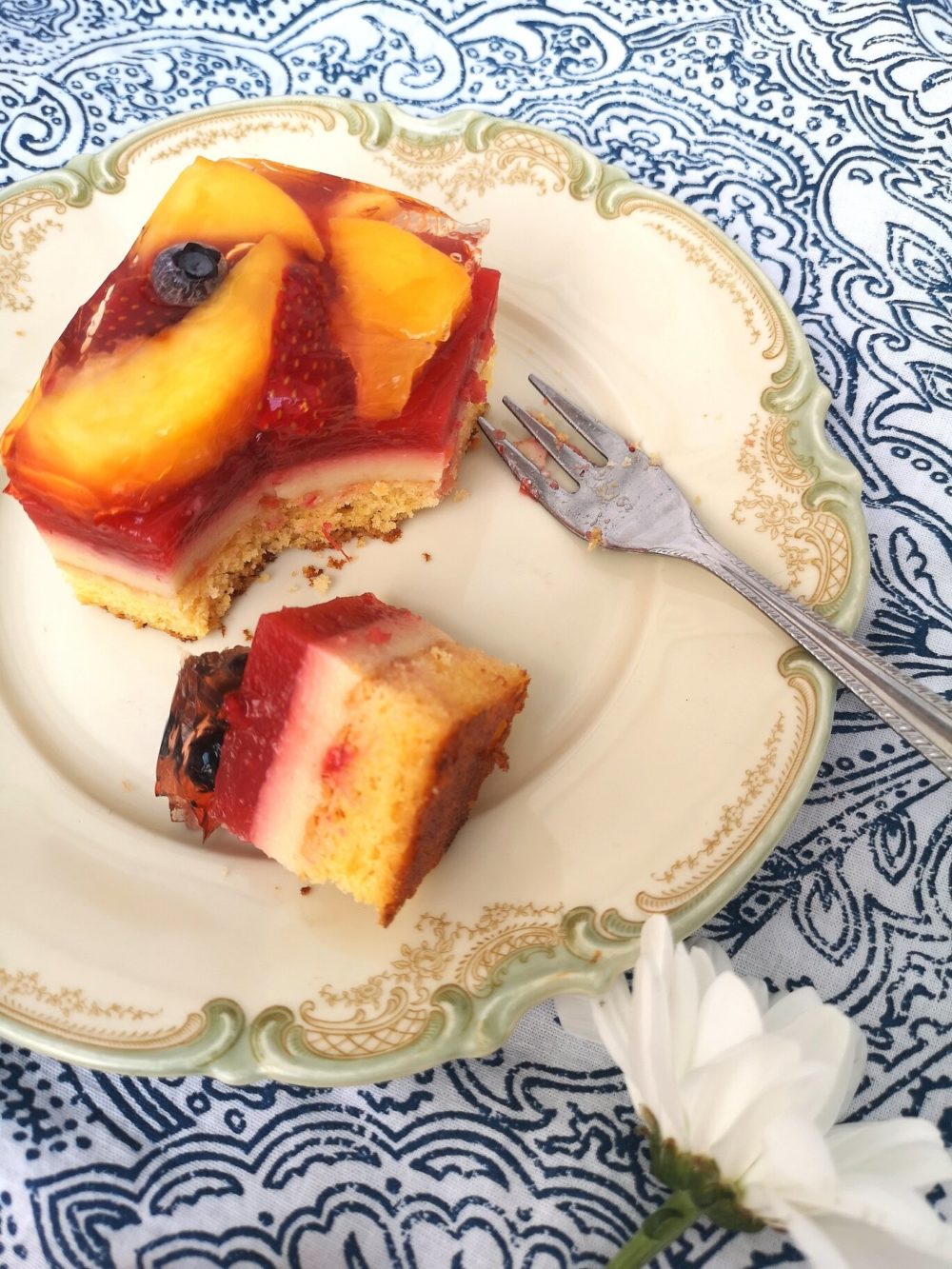 summer fruit cake bars on a white plate with a fork