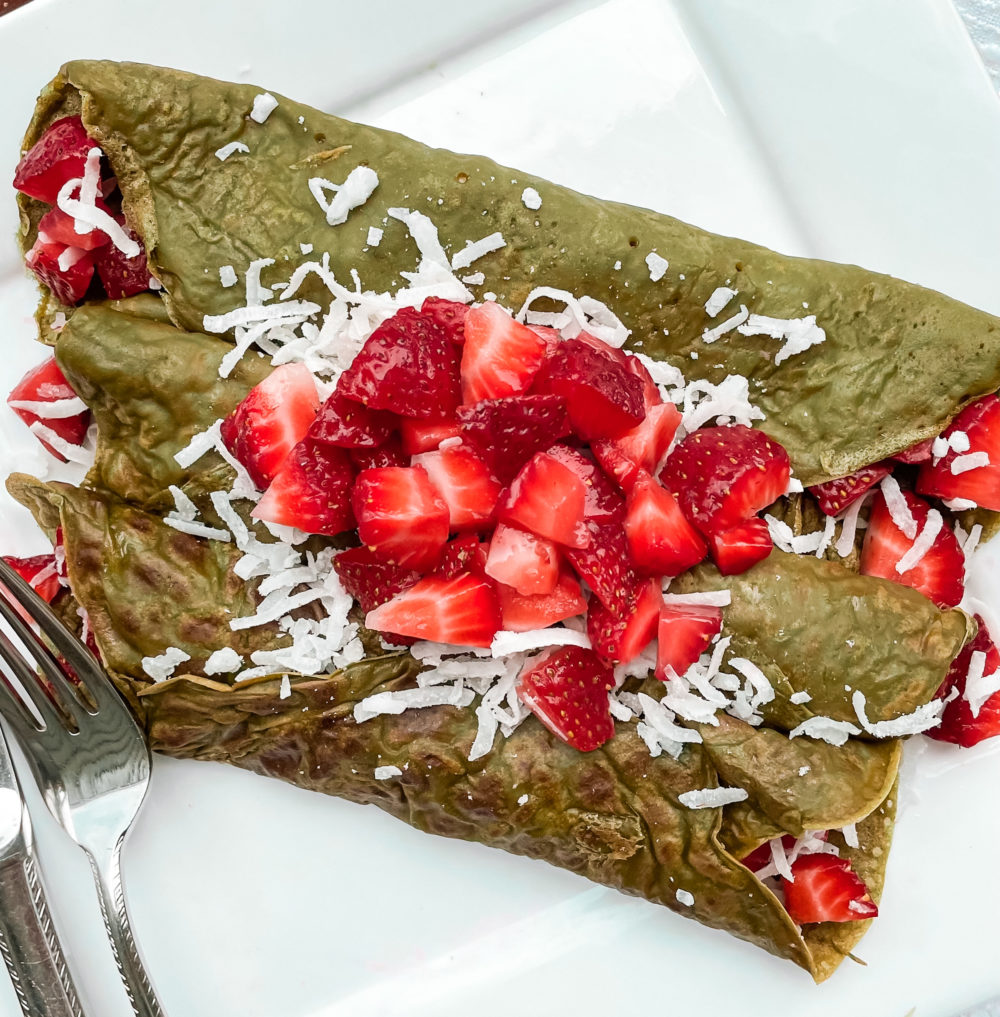 Matcha Dutch Pancakes with strawberries on a plate