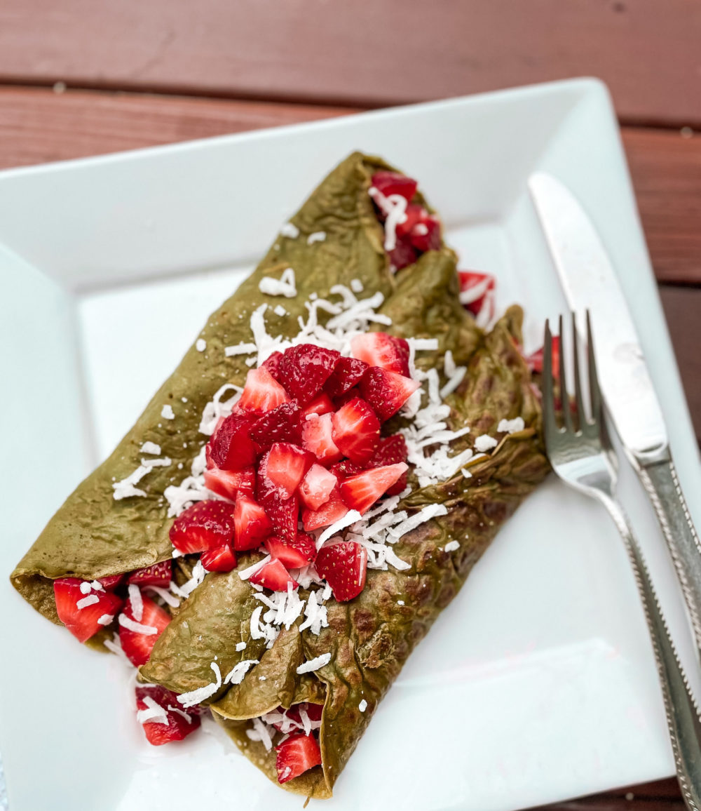 Matcha Dutch Pancakes on a white plate with silverware