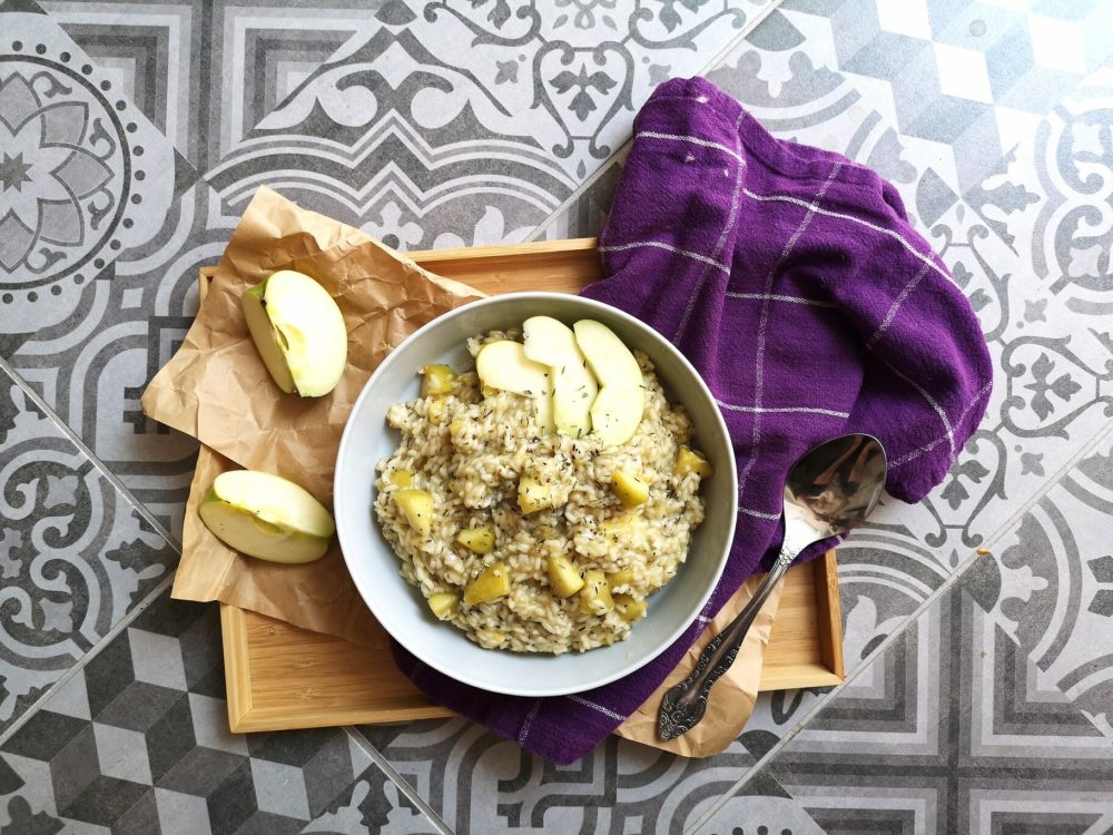 a bowl of apple risotto with smoky vegan cheese
