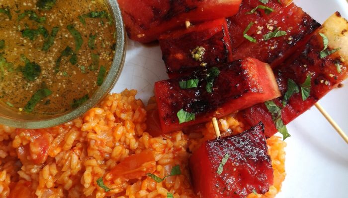 grilled watermelon and turkish rice on a white plate