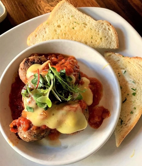 Vegan cheesy meatball bake from Plum Bistro in Seattle, Washington.