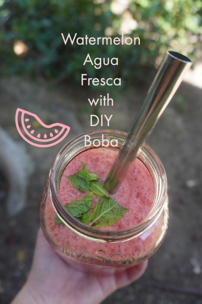 watermelon agua fresca bubble tea in a glass with a metal straw outside with overlayed caption