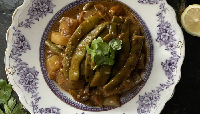 Greek Braised Green Beans on a decorative plate