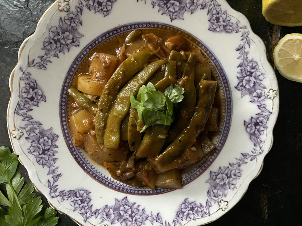 Greek Braised Green Beans on a decorative plate