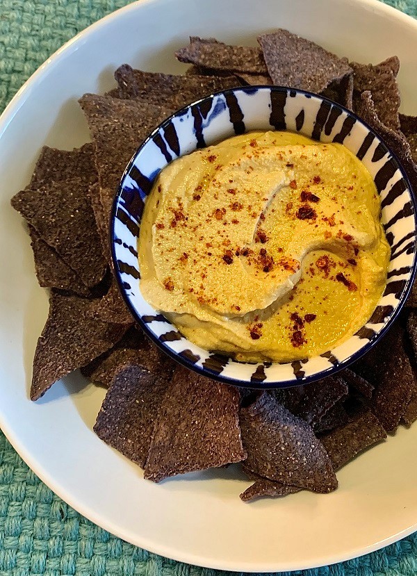 Sunflower seed queso dip with blue corn tortilla chips