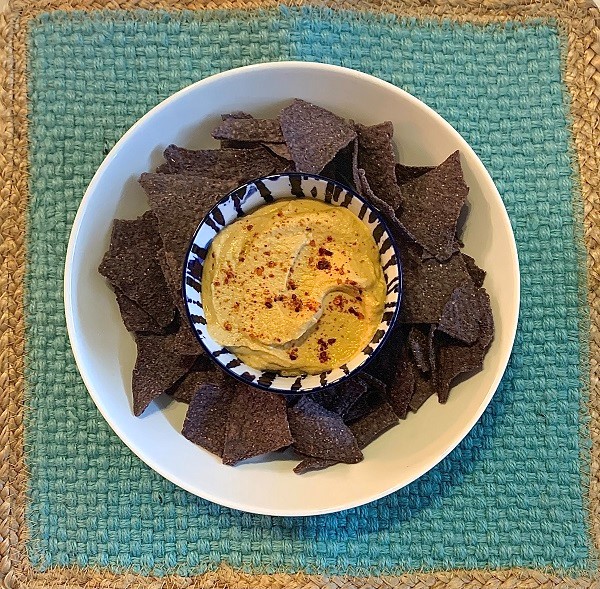 Sunflower seed queso dip with blue corn tortilla chips