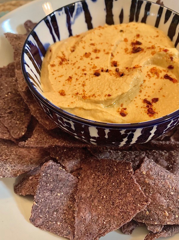 Sunflower seed queso dip with blue corn tortilla chips