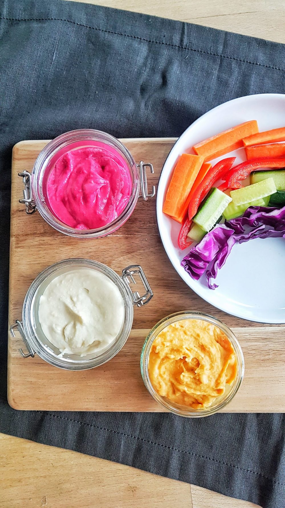 rainbow vegetable dips on a wooden tray