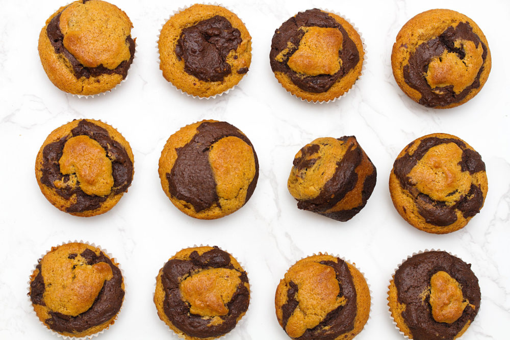 vegan pumpkin chocolate marble muffins on a white background