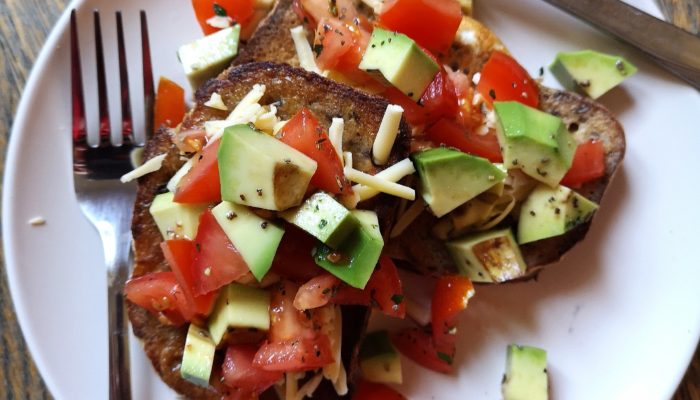 vegan mexican style "eggy" bread on a white plate with silverware