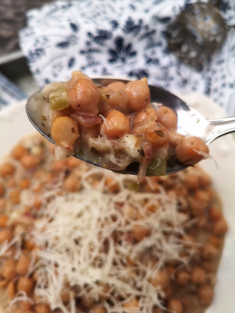 vegan cacio e pepe in a spoon above a dish