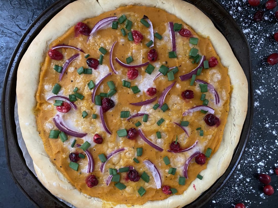 vegan butternut pizza with a dark background