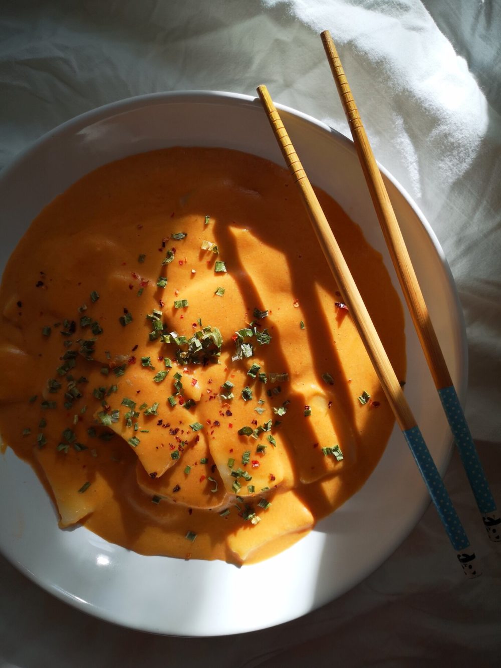 vegan cheese tteokbokki in a white bowl