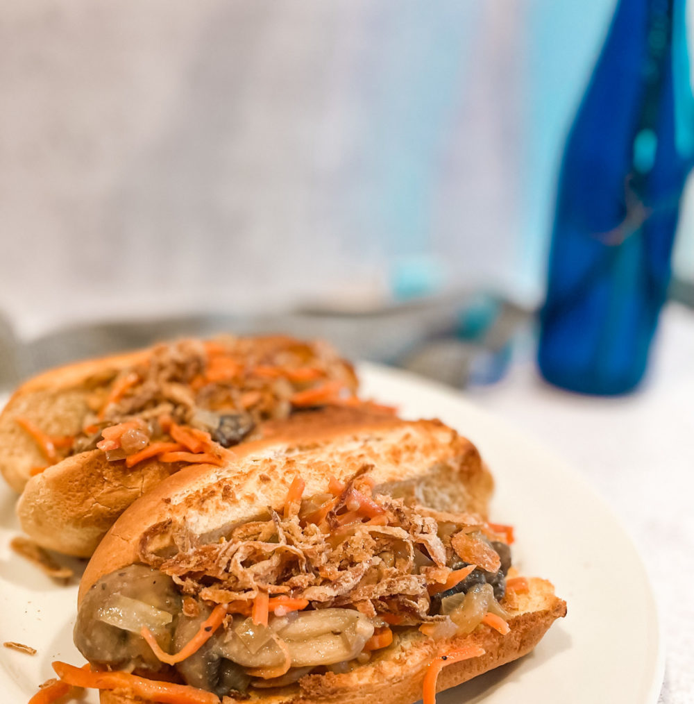 two hot dog buns with carrot mushroom slaw