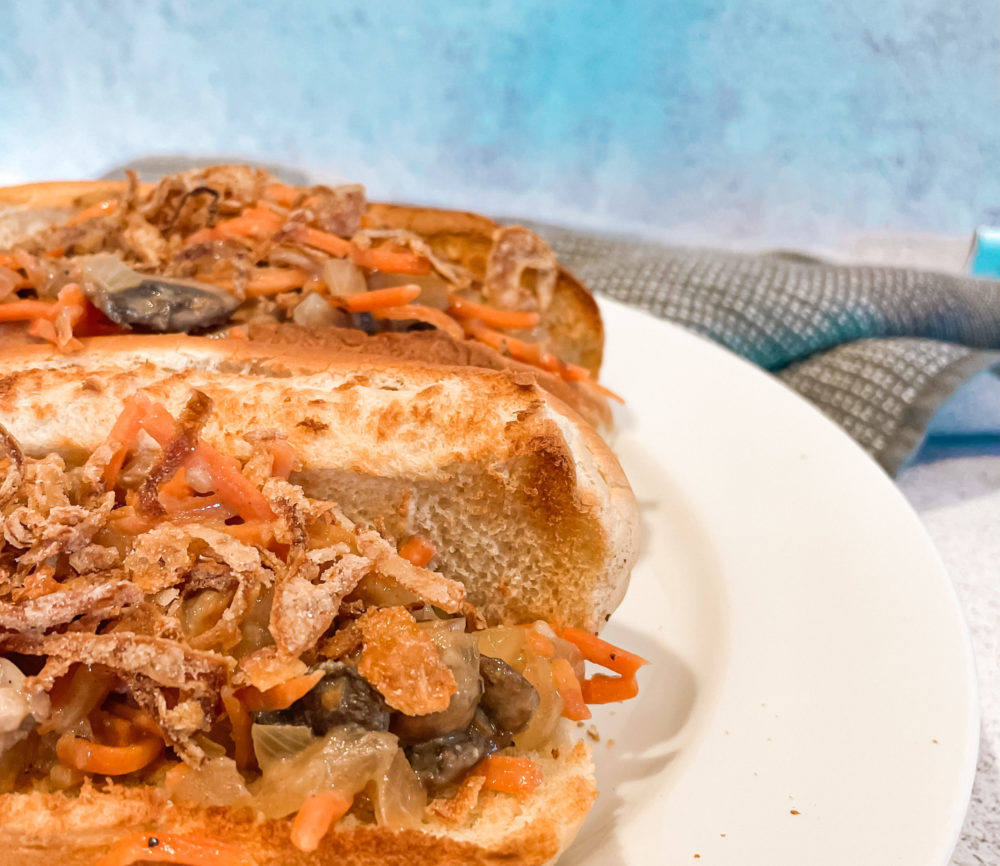 two hot dog buns with carrot mushroom slaw