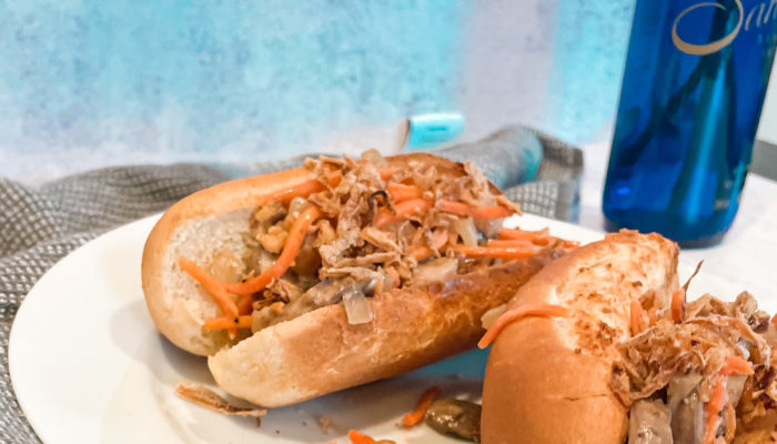 two hot dog buns with carrot mushroom slaw