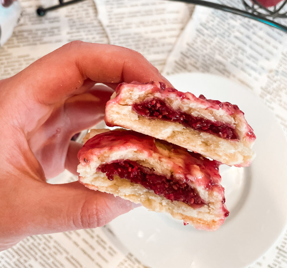 hand holding a cranberry pop tart split in half