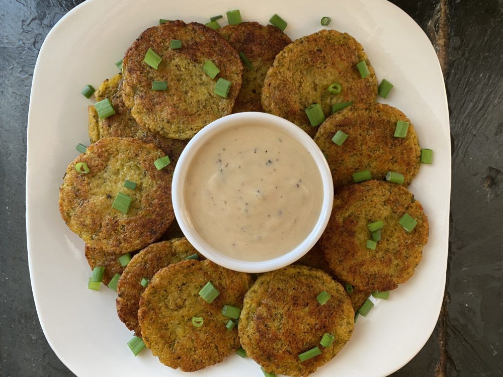 broccoli potato patties on a white plate