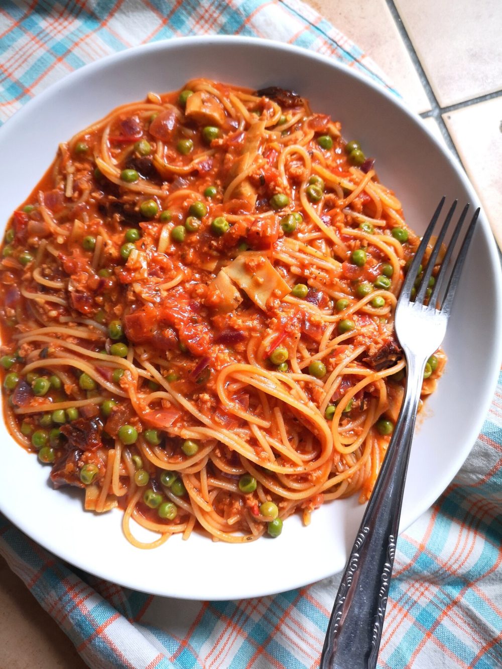 one-pot vegan pasta dish on a white plate with fork