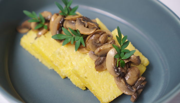 cheesy polenta cakes with balsamic mushrooms in a blue dish