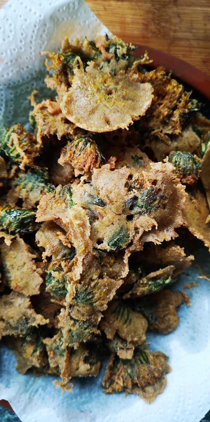 fried dandelions on a paper towel