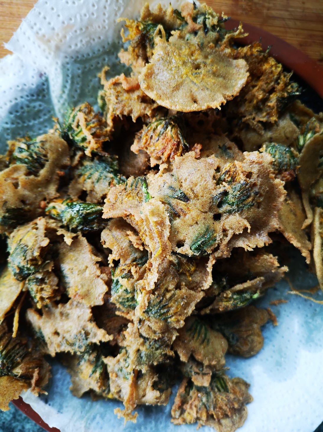 fried dandelions on a paper towel