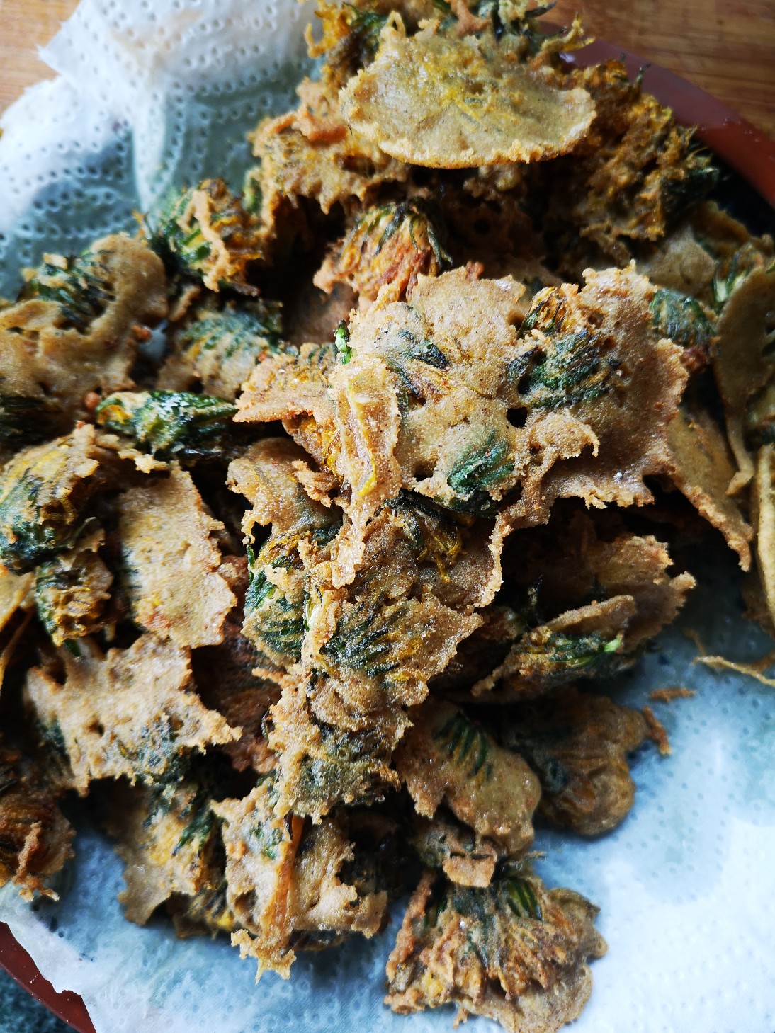 fried dandelions on a paper towel