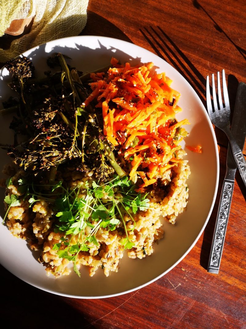 vegan brussels sprouts fried risotto on a plate with silverware