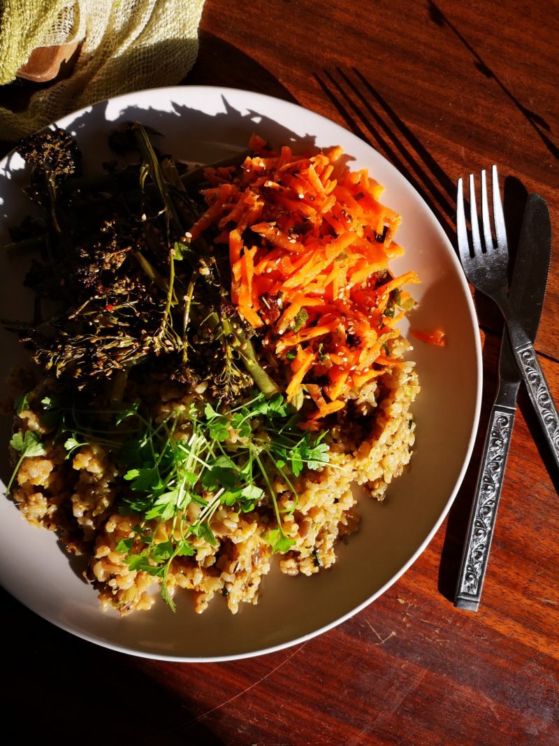 vegan brussels sprouts fried risotto on a plate with silverware