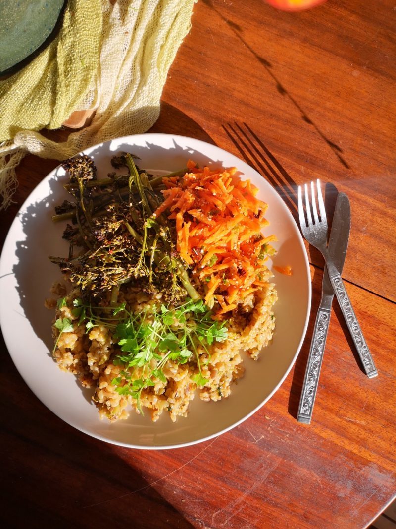 vegan brussels sprouts fried risotto on a plate with silverware