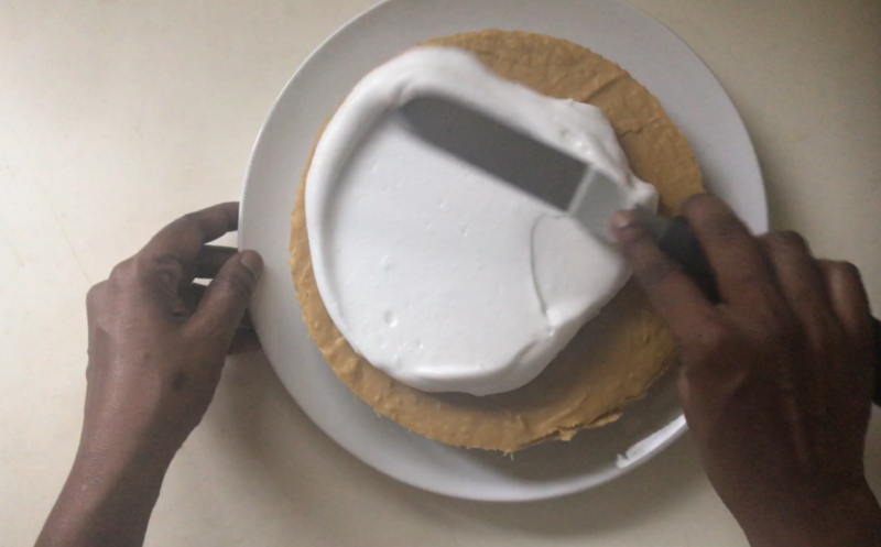 aquafaba meringue topping being spread onto a cake