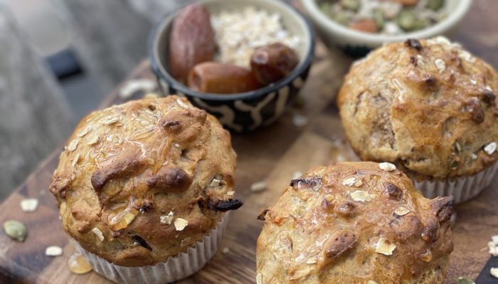 vegan muesli muffins with dates and seeds on a cutting board