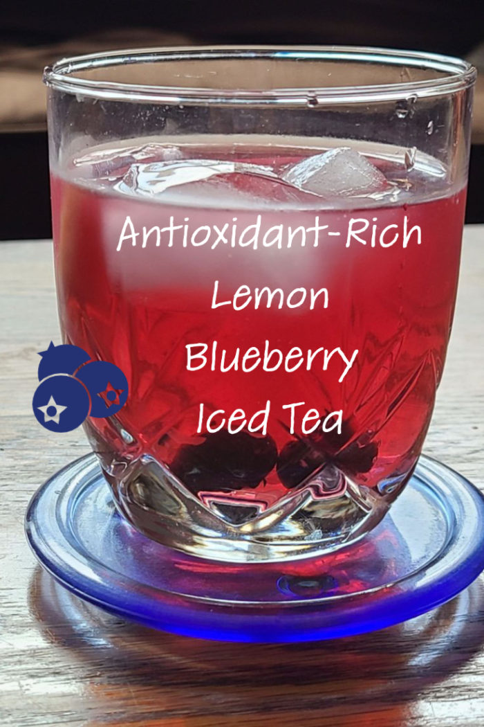 lemon blueberry iced tea in a glass with caption