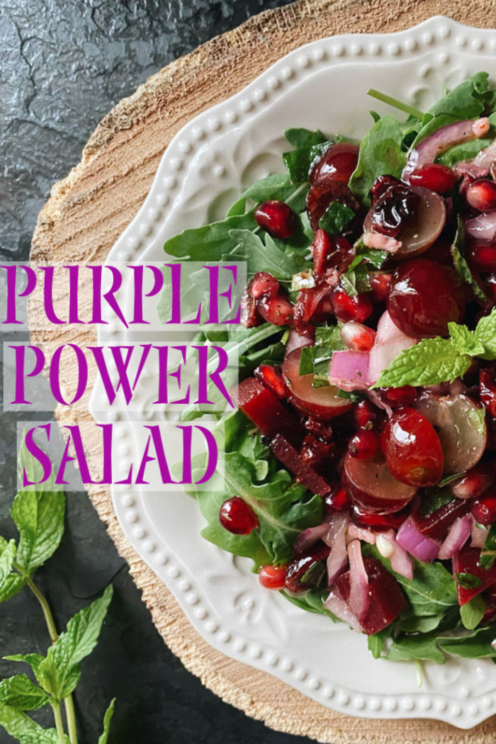 purple power salad on a white plate against a black and brown background with caption