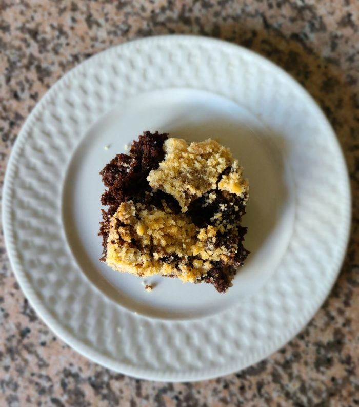 vegan molasses cake on a white plate on a marble countertop