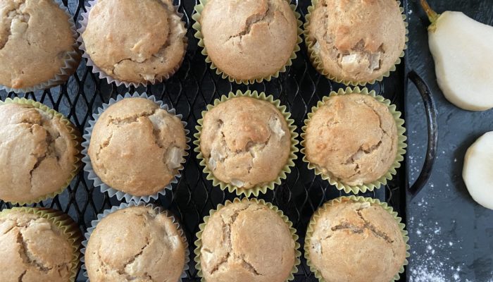 pear muffins on a black cooling rack
