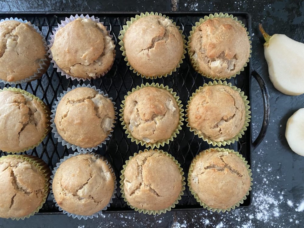 pear muffins on a black cooling rack