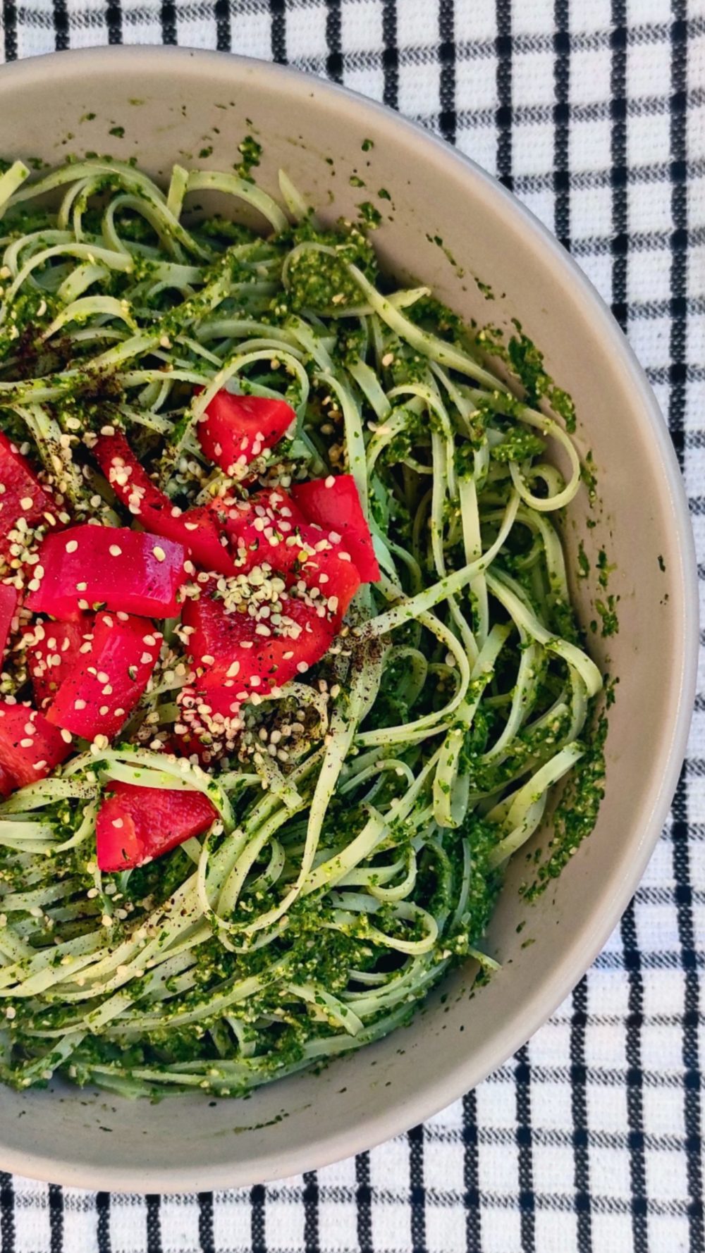 green goddess noodles in a white bowl against a black and white background