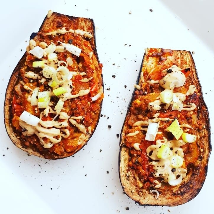 vegan maltese stuffed aubergine boats on a white background