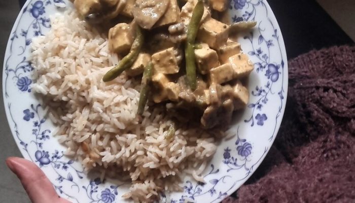 creamy tofu stew on a white and blue floral plate